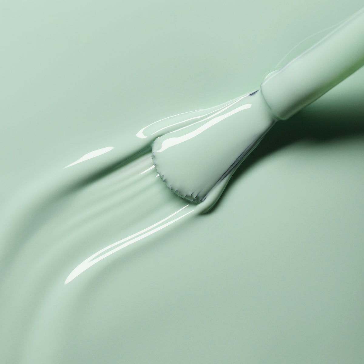 A close-up of a brush applying Manucurist&