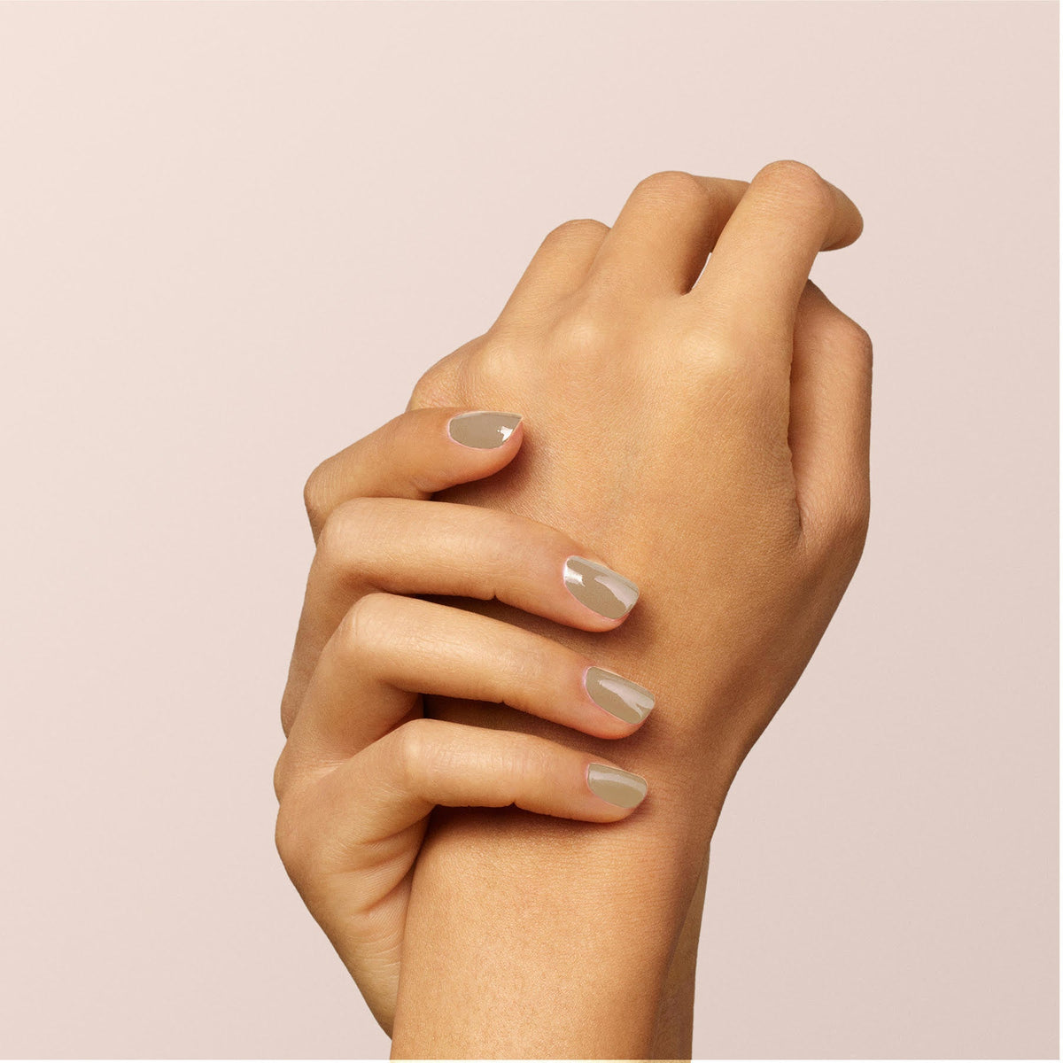 A close-up of two hands with neatly manicured nails painted in Manucurist&