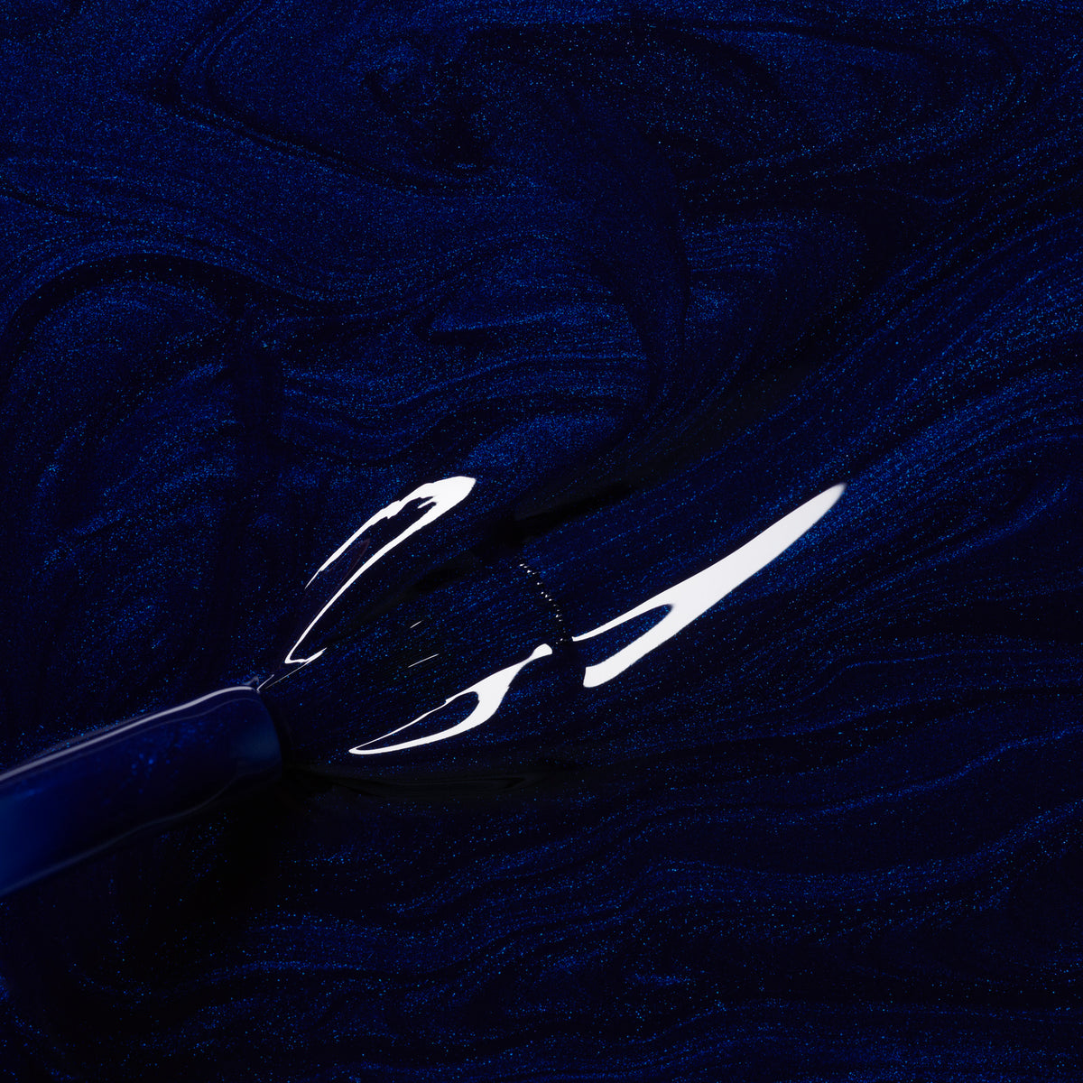 A close-up of a brush dipped in Manucurist&