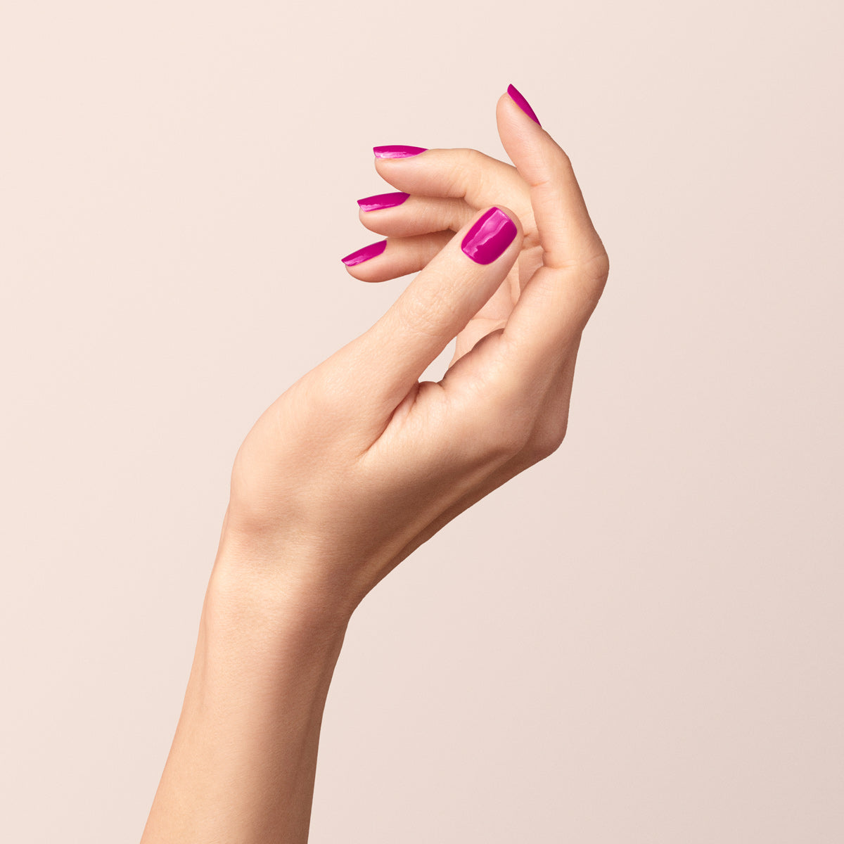A hand with neatly manicured nails painted in Manucurist&