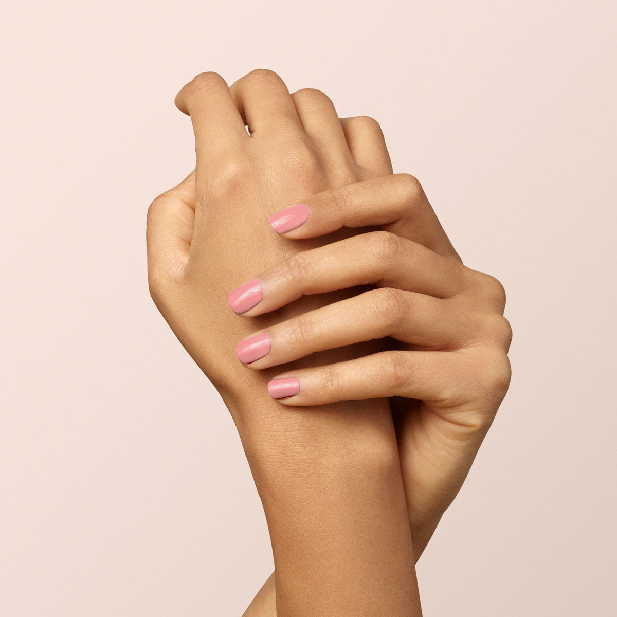 Two hands with neatly manicured nails painted in Manucurist&